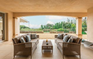 location - Pampres - Modern outdoor terrace with garden view  location - Pampres - This image shows a modern outdoor terrace with wicker sofas and a stunning view of a lush garden. The space is ideal for relaxing and enjoying nature.