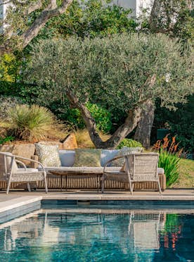 location - Albelia - Garden with pool and outdoor furniture  location - Albelia - Image of a lush garden with a pool, comfortable outdoor furniture, and green trees.