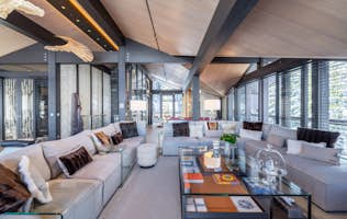 accommodation - Chalet B  - Modern living room with elegant decor  accommodation - Chalet B  - This modern living room features elegant decor with comfortable sofas, integrated lighting, and a stunning view of the outdoors.