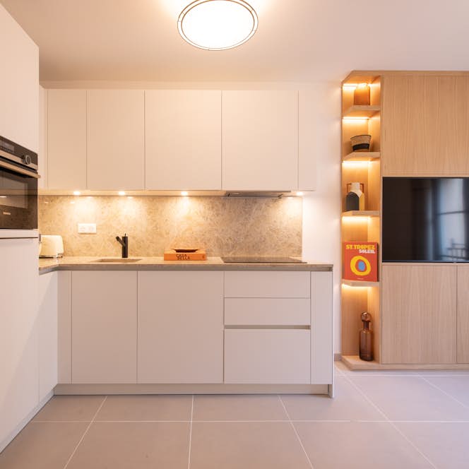 location - Oscar - Modern and elegant kitchen  location - Oscar - This modern and elegant kitchen features white cabinets, a marble countertop, and warm ambient lighting. Perfect for contemporary design enthusiasts.