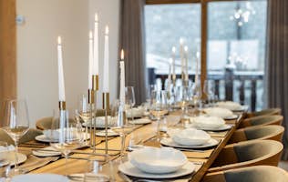 location - Les Arolles  - Elegant Dining Table with Decorations  location - Les Arolles  - Elegantly decorated dining table with candles and wine glasses, perfect for family meals or dinner parties.