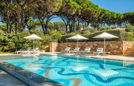 location - Canoubwest - Pool with lounge chairs and umbrellas in a lush garden  location - Canoubwest - Image of a beautiful pool with lounge chairs and umbrellas in a lush and well-maintained garden. Perfect for relaxation and leisure time.