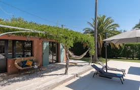 location - Beausoleil - Tropical Terrace with Hammock and Outdoor Furniture  location - Beausoleil - This image shows a tropical outdoor terrace with a hammock, lounge chairs, and lush greenery. The space is perfect for relaxing and enjoying the nice weather.