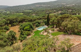 location - La Ribote - Panoramic view of a house with pool and garden  location - La Ribote - This image shows a house surrounded by a beautiful garden with a pool, located in a natural and green setting.