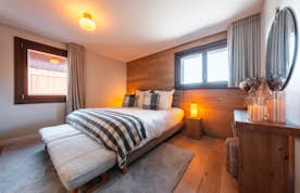 accommodation - Arpont  - Modern and Cozy Bedroom  accommodation - Arpont  - This modern and cozy bedroom features a comfortable bed with flannel sheets, wooden flooring, and elegant decor. Perfect for a restful sleep.