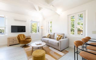 location - Riviera - Modern and Bright Living Room  location - Riviera - Discover this modern and bright living room with a comfortable sofa, a designer armchair, and elegant decor. Perfect for relaxing and entertaining.