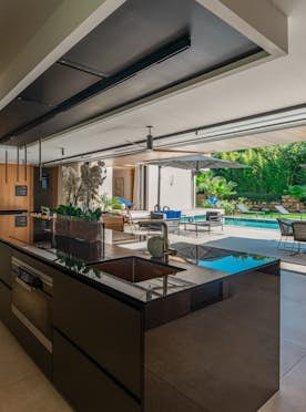 location - Jeanne - Modern dining room with pool view  location - Jeanne - This image shows a modern dining room with a stunning view of an outdoor pool. The space is elegantly designed with contemporary furniture and sophisticated interior decor.